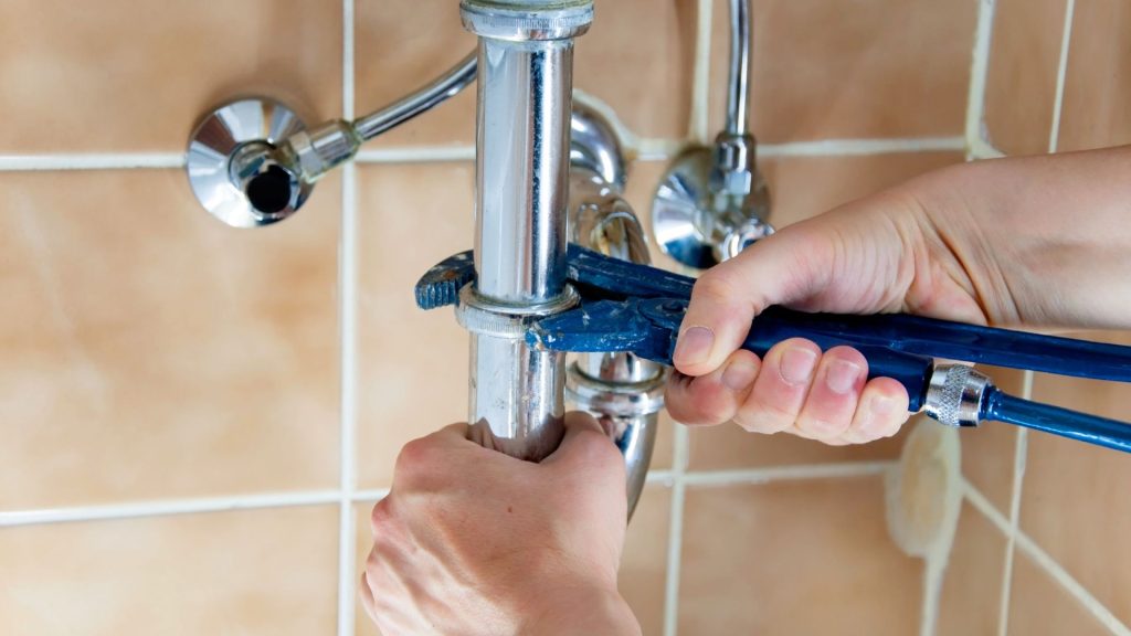 plumber tightening pipes