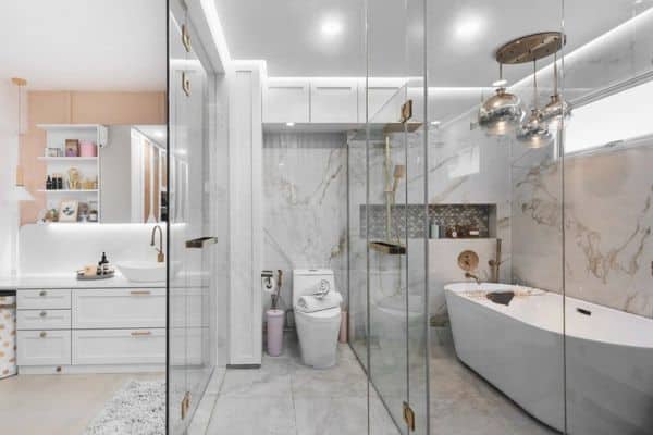 Luxury HDB bathroom renovation by Siam Engineering featuring marble walls, a freestanding tub, and gold accents.